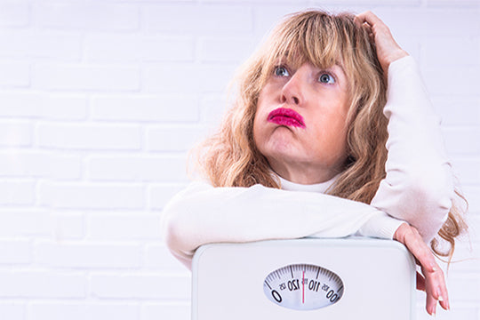 woman with scale wonders about diet and exercise