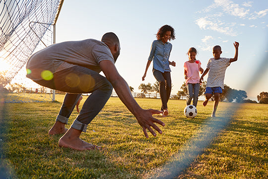 happy family plays soccer