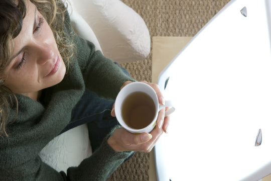 woman in front of light box for SAD