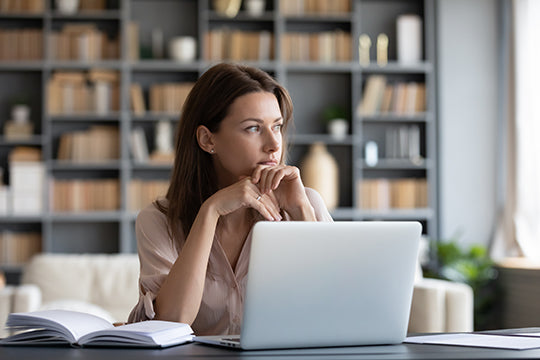thoughtful woman at desk