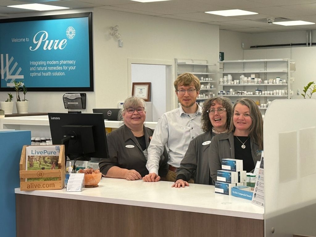 Group of Pure pharmacists and natural health advisors at a Pure Pharmacy retail counter